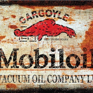 May include: A vintage, rusty metal sign advertising Mobiloil Vacuum Oil Company Ltd. The sign features a red gargoyle with the text "Gargoyle Reg. Trade Mark" above the Mobiloil logo.