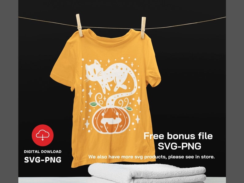 May include: A yellow t-shirt featuring a white graphic of a cat perched on a pumpkin. The text "Free bonus file SVG-PNG" and "We also have more svg products, please see in store." is printed on the shirt.