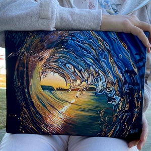 May include: A painting depicting a wave breaking, with a golden sunset visible through the crest. The wave is painted in shades of blue, green, and gold, with a textured effect to represent the water.