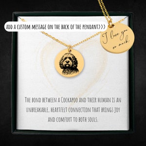 May include: Gold necklace with a round pendant featuring a black and white illustration of a Cockapoo dog. The pendant has a message on the back that reads "I love you so much".
