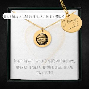 May include: A gold necklace with two round pendants. The larger pendant features a detailed image of Jupiter. The smaller pendant has the handwritten message "I love you so much".