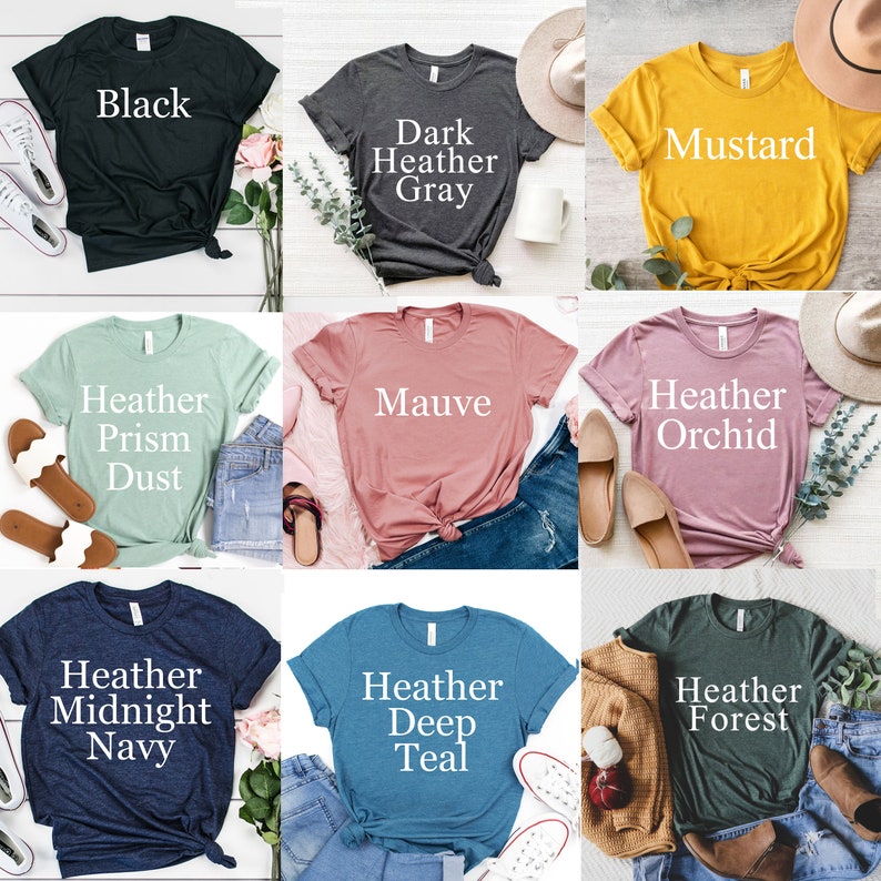 May include: Nine different color t-shirts with text describing the color of each shirt. The colors are black, dark heather gray, mustard, heather prism dust, mauve, heather orchid, heather midnight navy, heather deep teal, and heather forest.