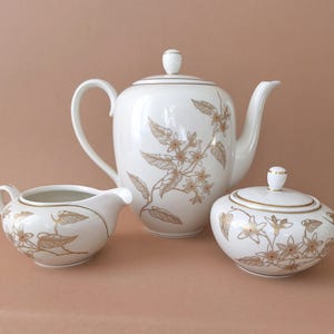 Conjunto de porcelana Lettin, cafeteira, açucareiro e jarra de creme com borda dourada