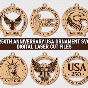 May include: A collection of laser-cut wooden ornaments with patriotic themes. Designs include eagles, the Statue of Liberty, and the text "Celebrating 250 Years of Freedom." The ornaments display the years 1776-2026.