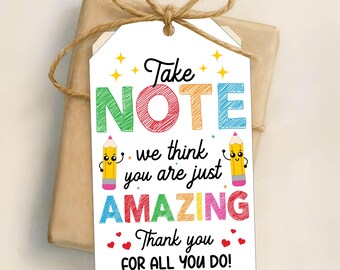 May include: A white gift tag with colorful text that reads "Take Note - we think you are just AMAZING. Thank you for all you do!"  The tag features two cartoon pencils with smiling faces.