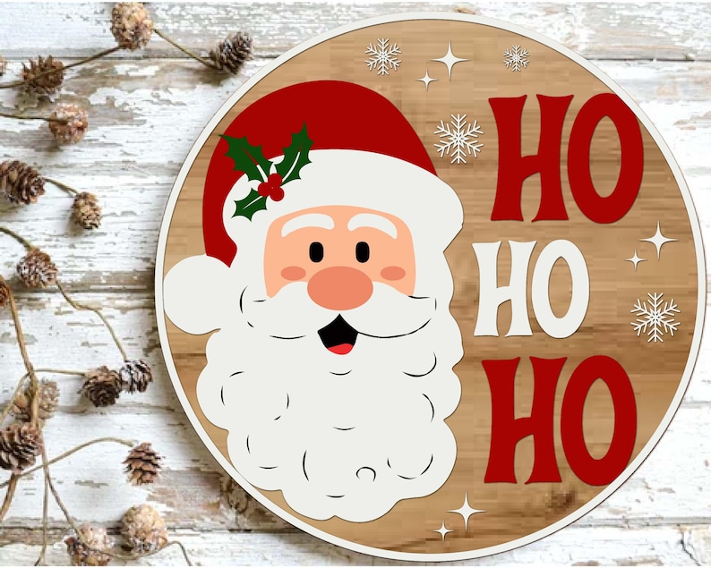 May include: Round wooden Christmas sign featuring Santa Claus with a red hat and the words "HO HO HO" in red. The sign has a light wood grain background with white snowflakes and stars.