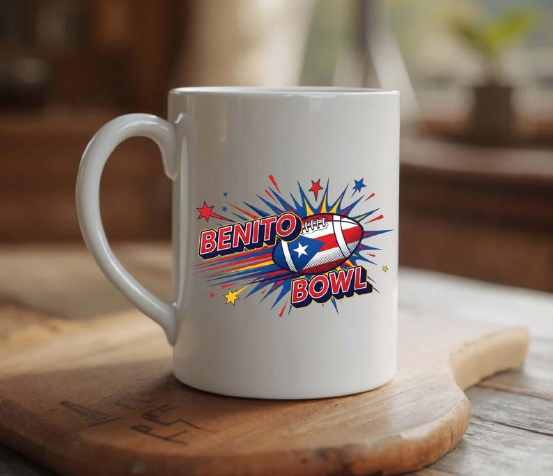 May include: White ceramic mug featuring the words "BENITO BOWL" in a comic book style font. The design includes a football with the Puerto Rican flag and starbursts in red, blue, and yellow. The mug has a curved handle.