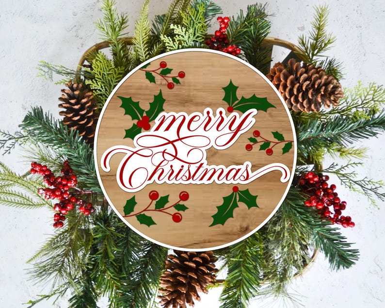 May include: A Christmas wreath with a wooden center displaying the words "Merry Christmas" in red script. The wreath is decorated with green pine needles, red berries, holly leaves, and pine cones.