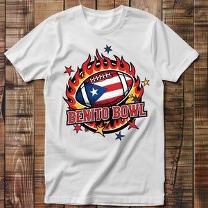May include: White t-shirt featuring a football with the Puerto Rican flag design, surrounded by flames and stars. The text "BENITO BOWL" is displayed in a bold, red font. The shirt is made of a soft material.