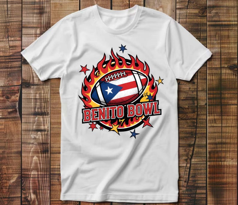 May include: White t-shirt featuring a football with the Puerto Rican flag design, surrounded by flames and stars. The text "BENITO BOWL" is displayed in a bold, red font. The shirt is made of a soft material.