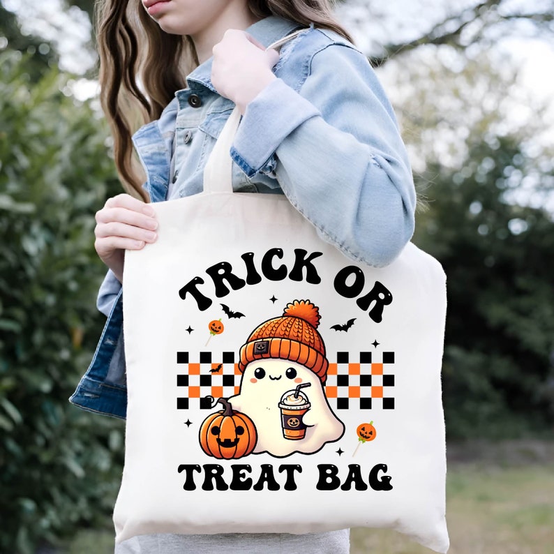 May include: White tote bag with a cute cartoon ghost wearing a beanie and holding a cup of coffee. The bag has the text "Trick or Treat Bag" printed on it.