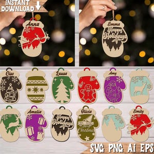 May include: Wooden Christmas ornament shaped like a mitten, with various designs and names. Some ornaments have a name at the top, such as "Anna" and "Emma". Other ornaments have holiday-themed designs like a Christmas tree, Santa, and a reindeer.