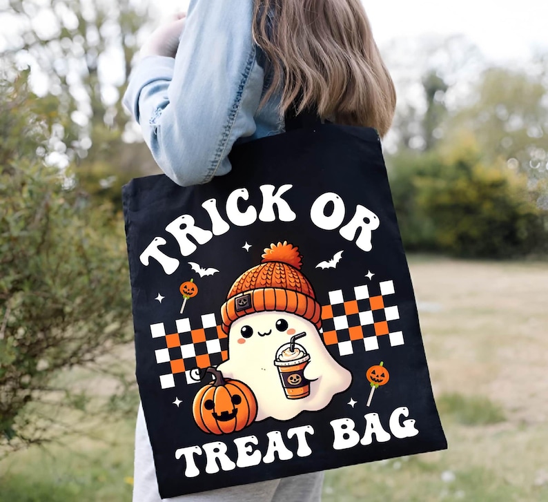May include: Black canvas tote bag with the text "Trick or Treat Bag" in white retro font. A cartoon ghost wearing a knitted orange and brown hat holds a cup of coffee and is next to a jack-o-lantern.
