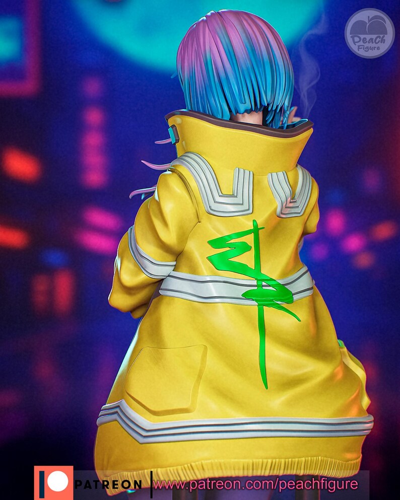 May include: A figurine of a character with blue and pink hair, wearing a yellow jacket with a green design on the back. The jacket has white and silver accents. The figure is set against a blurred, dark background with neon lights. The text "Peach Figure" is visible.
