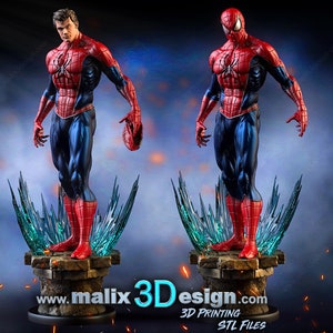 May include: A red and blue superhero figurine of Spider-Man standing on a base with a blue and green ice effect. The figurine is posed with one hand raised and the other holding a web shooter. The base has the text "www.malix3Ddesign.com 3D PRINTING STL FILES".