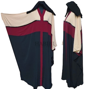May include: A long, black abaya with a burgundy and beige geometric pattern. The abaya has a hood and a V-neckline. The text "HABIBI COLLECTIONS" is printed on the front of the abaya.