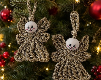 May include: Two handmade angel ornaments crafted from metallic gold yarn with a crocheted dress and wing design. Each angel features a round wooden bead head with a painted face including black eyes, a small nose, and a smiling red mouth.