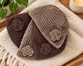 May include: Three crocheted beanies in varying shades of brown, each featuring a single crocheted flower appliqué. The hats are crafted with a textured stitch pattern and display a consistent design, showcasing dark brown, medium brown, and tan tones.