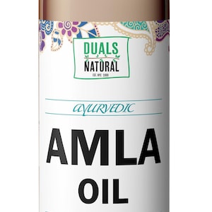 May include: A brown plastic bottle with a gray flip-top cap containing Amla oil. The label features the text Duals Natural Est. NYC 1989, Ayurvedic, Amla Oil, and Moisturize & Strengthen Prevent Hair Loss, with images of three green amla fruits.