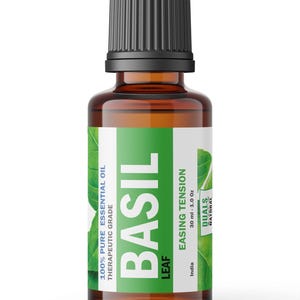 May include: A 1.0 oz amber glass bottle of basil essential oil with a black ribbed cap. The white and green label features the text BASIL, 100% PURE ESSENTIAL OIL, THERAPEUTIC GRADE, EASING TENSION, 30 ml - 1.0 oz, India, and the brand name DUALS NATURAL.