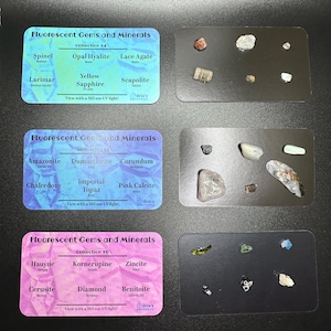 May include: Four cards with a pink, blue, and purple background. Each card has a title "Fluorescent Gems and Minerals" and lists different gems and minerals with their origins. Each card has a small sample of the gem or mineral on a black background.
