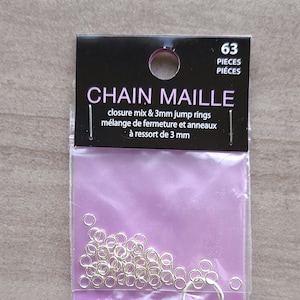 May include: A package of jewelry-making supplies. The package contains 63 pieces of chain maille, closure mix, and 3mm jump rings. The package has the text "CHAIN MAILLE" and "closure mix & 3mm jump rings".