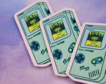 May include: Three green and white Game Boy Color stickers with the text "Nintendo YA RNBOY" and "TOP-DEAD START" and "GOODS NENE" on the screen.
