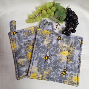 May include: A set of three ceramic mugs with a speckled, matte finish in cream, light grey, and dark grey. Each mug has a simple, minimalist design and a rounded handle.