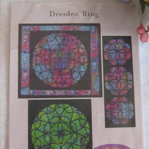 May include: A quilting pattern for a Dresden Ring quilt. The pattern includes three different sizes of the ring design, with a colourful, stained glass look. The text "Dresden Ring" is at the top of the pattern.