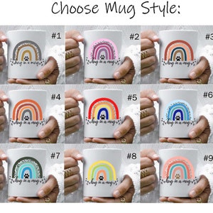 May include: Nine different styles of white ceramic mugs with a rainbow design and the text "Hug in a mug" in black. Each mug has a different color scheme for the rainbow.