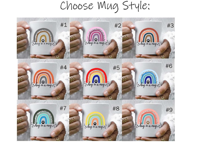 May include: Nine different styles of white ceramic mugs with a rainbow design and the text "Hug in a mug" in black. Each mug has a different color scheme for the rainbow.