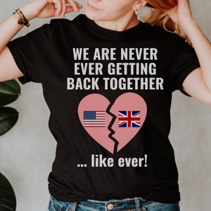May include: Black t-shirt with the text "We are never ever getting back together... like ever!" and a broken heart with the American and British flags on each side.