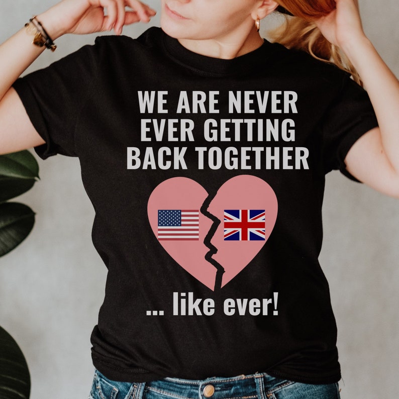 May include: Black t-shirt with the text "We are never ever getting back together... like ever!" and a broken heart with the American and British flags on each side.