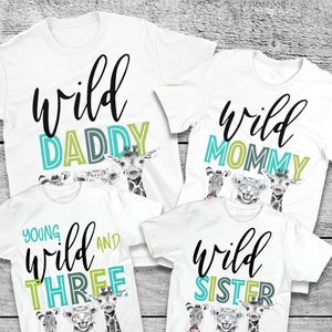 May include: Set of four white t-shirts with a wild animal theme. The shirts say "Wild Daddy", "Wild Mommy", "Young Wild and Three", and "Wild Sister".