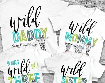 May include: Set of four white t-shirts with a wild animal theme. The shirts say "Wild Daddy", "Wild Mommy", "Young Wild and Three", and "Wild Sister".