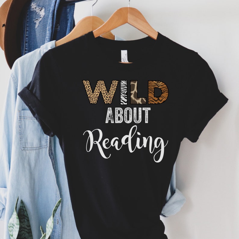 May include: Black t-shirt with the text "WILD ABOUT Reading" in white. The word "WILD" is made up of animal print letters.