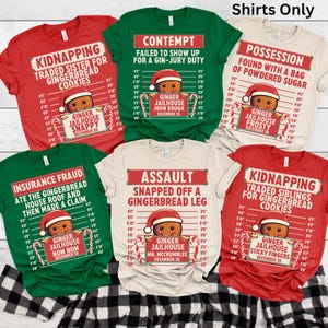 May include: A collection of six colorful t-shirts with humorous gingerbread man mugshot designs. Each shirt features a different "crime" and a gingerbread man wearing a Santa hat. The shirts are red, green, and beige, with black text and candy cane accents.