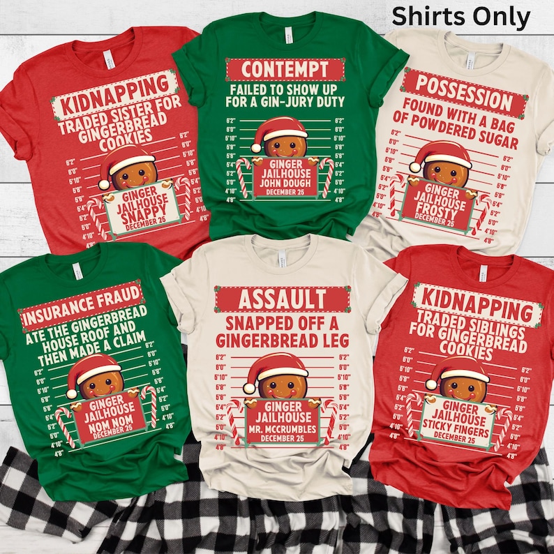 May include: A collection of six colorful t-shirts with humorous gingerbread man mugshot designs. Each shirt features a different "crime" and a gingerbread man wearing a Santa hat. The shirts are red, green, and beige, with black text and candy cane accents.