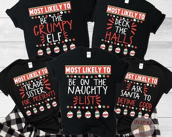May include: Five black t-shirts with white text and red and green accents. The shirts say "Most Likely To" and have different Christmas-themed phrases. The phrases are "Be the Grumpy Elf", "Deck the Halls", "Trade Sister for Presents", "Be on the Naughty List", and "Ask Santa to Define Good".