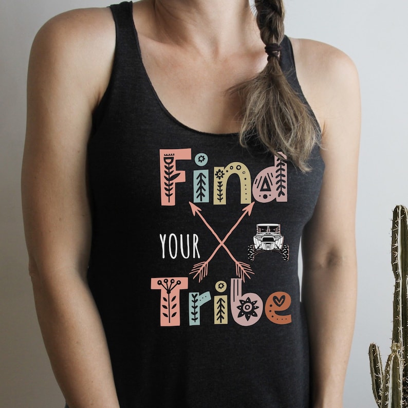 May include: Black tank top with a colourful graphic that says "Find Your Tribe" with a stylised off-road vehicle and arrows.