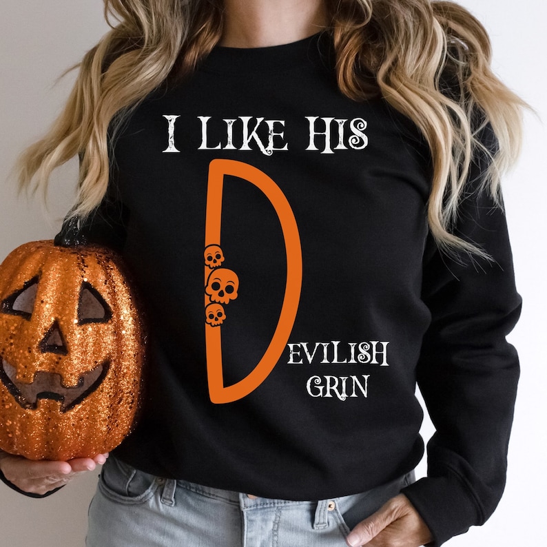 May include: Black sweatshirt with the text "I like his D. Evilish Grin" in white. The "D" is orange and has three small white skulls inside it.