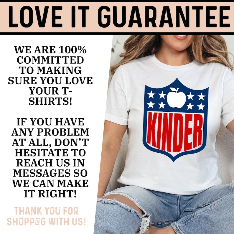 May include: White t-shirt with a red, white, and blue shield design. The shield has an apple and stars and the word "KINDER" in red letters.