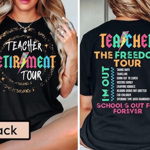 May include: Black t-shirt with the words "Teacher Retirement Tour" in colorful text with a lightning bolt graphic. The back of the shirt says "Teacher The Freedom Tour" with a list of activities and "School's Out For Forever."