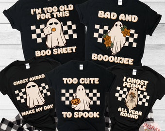 May include: Black t-shirts with ghost graphics and text. Designs include "I'm too old for this Boo Sheet", "Bad and Booooujee", "Ghost Ahead Make My Day", "Too Cute to Spook", and "I Ghost People All Year Round".