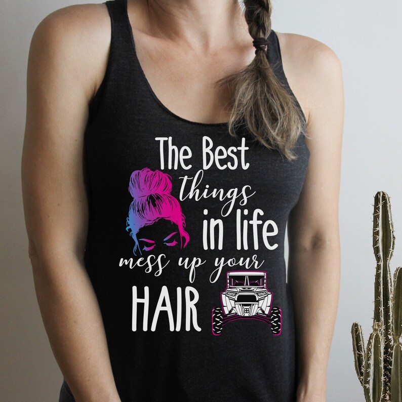 May include: A black tank top with the text "The Best things in life mess up your HAIR" and a graphic of a woman with a messy bun and a side-by-side off-road vehicle.