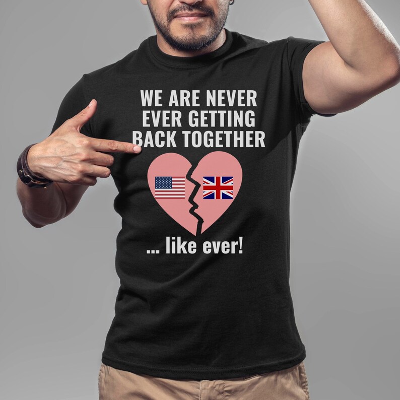 May include: Black t-shirt with a broken heart graphic featuring the American and British flags. The text on the shirt reads "We are never ever getting back together... like ever!"