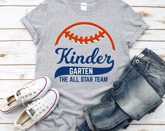 May include: Grey t-shirt with a blue and orange baseball graphic and the text "Kinder Garten The All Star Team".