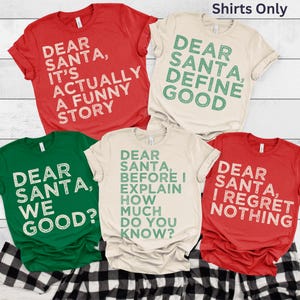 May include: Five t-shirts with holiday-themed text. The shirts are red, green, and beige, with phrases like "Dear Santa, It's Actually a Funny Story" and "Dear Santa, We Good?" printed in white or green.