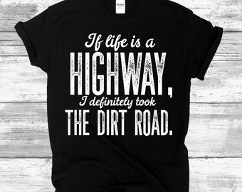 May include: Black t-shirt with white text that reads "If life is a HIGHWAY, I definitely took THE DIRT ROAD."