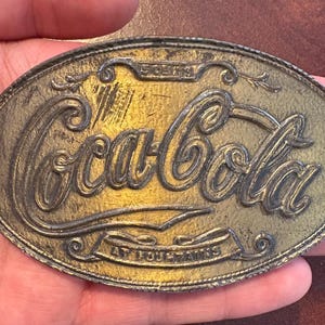 Vintage Coca-Cola Belt Buckle – “5 Cents at Fountains” Brass-Toned Cast Metal